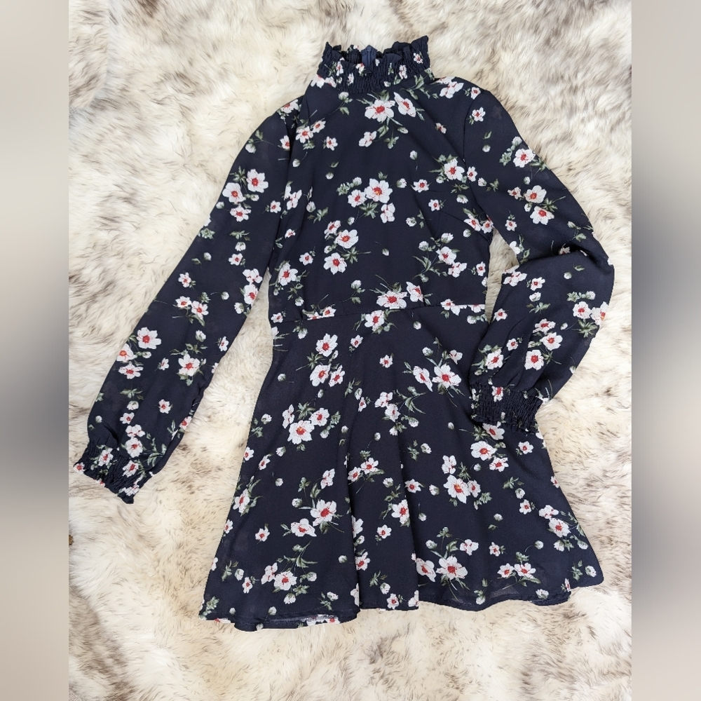 Stylish brand new, navy blue dress with white flowers, long sleeves.
